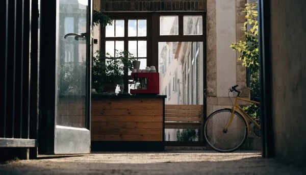 A café doorway and bicycle in a realistic cinematic style